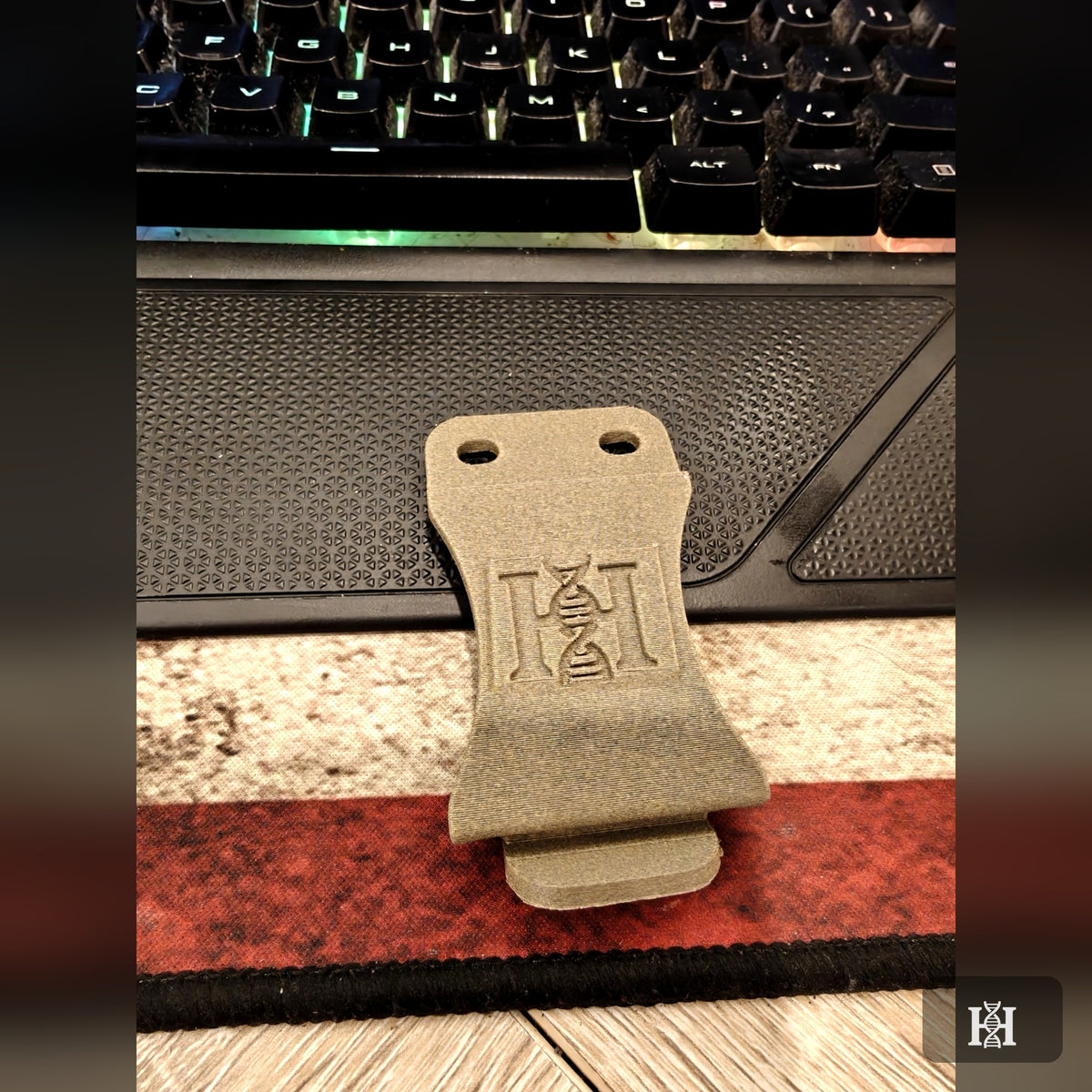 Close-up of 3D-printed FDE belt clip with embossed Hyde logo