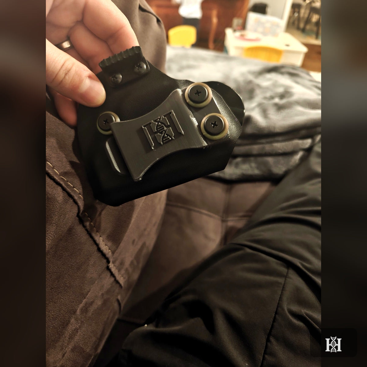 Back of black AIWB holster showing embossed Hyde-logo belt clip