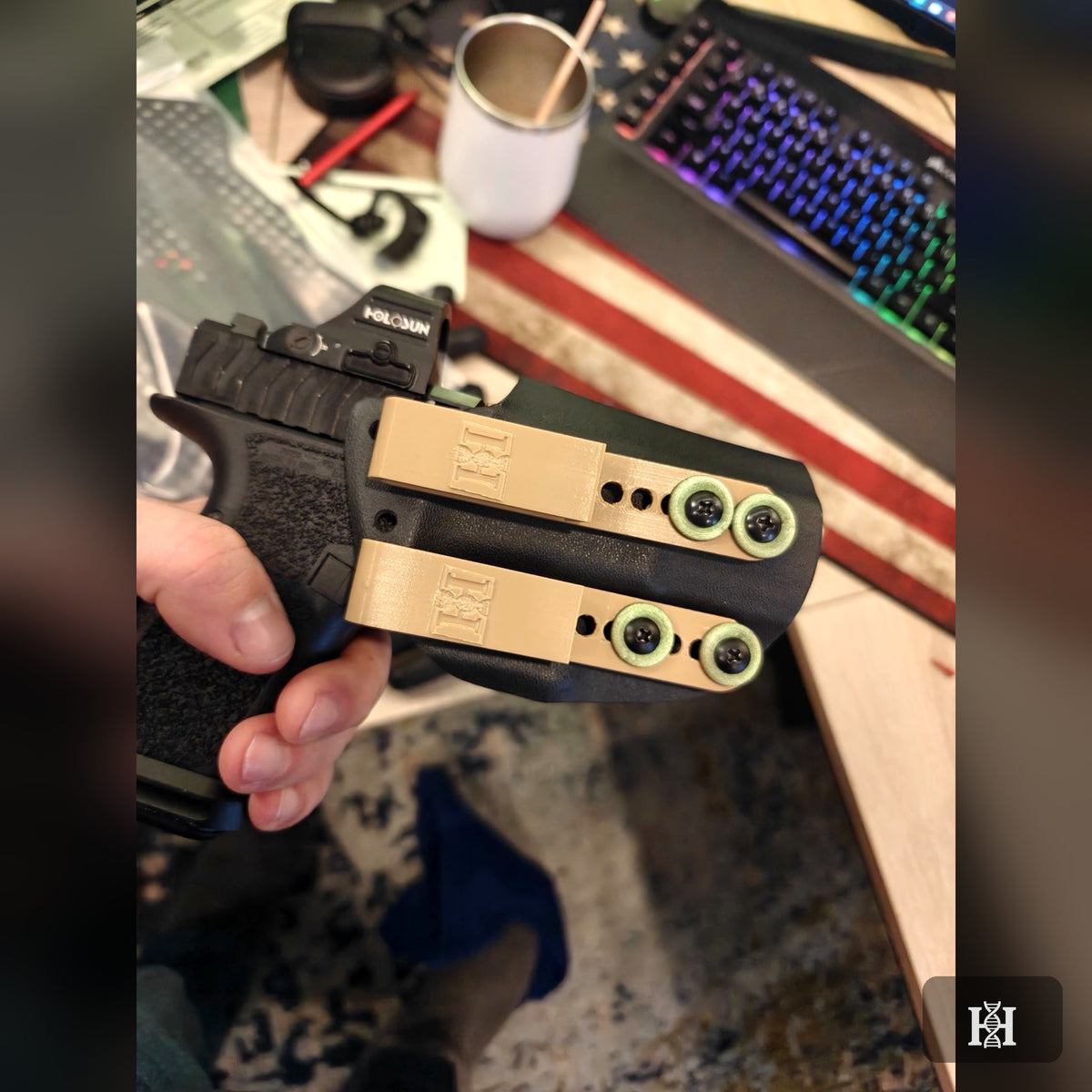 Black AIWB Kydex holster with FDE belt clips, green hardware, holding pistol with Holosun optic