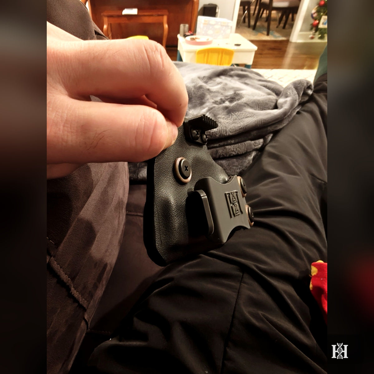Side view of black AIWB holster with Holosun-equipped pistol and Hyde-logo clips