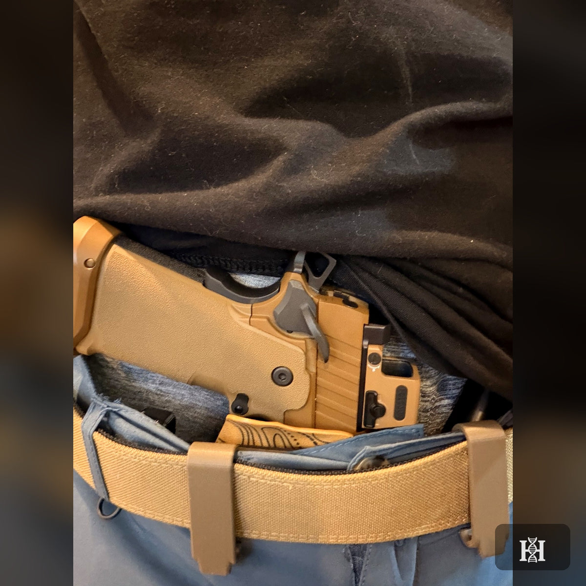 Tan topo-print AIWB holster worn inside the waistband with FDE 1911