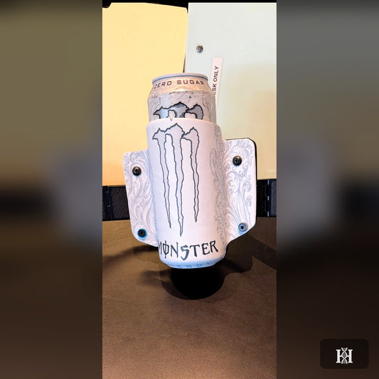 White Kydex energy drink can holder with claw-mark graphic, holding a slim can