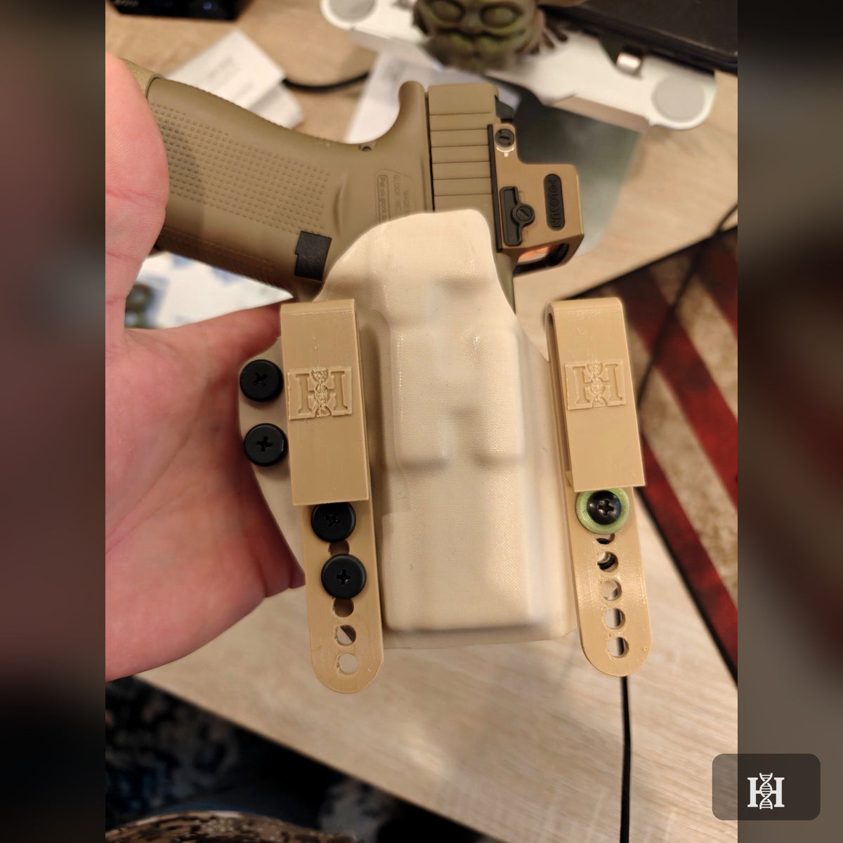 FDE OWB Kydex holster holding a Glock with Holosun optic, FDE belt loops with Hyde logo