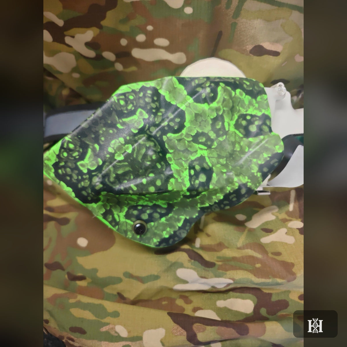 Neon green splatter-print OWB Kydex shell on camouflage fabric
