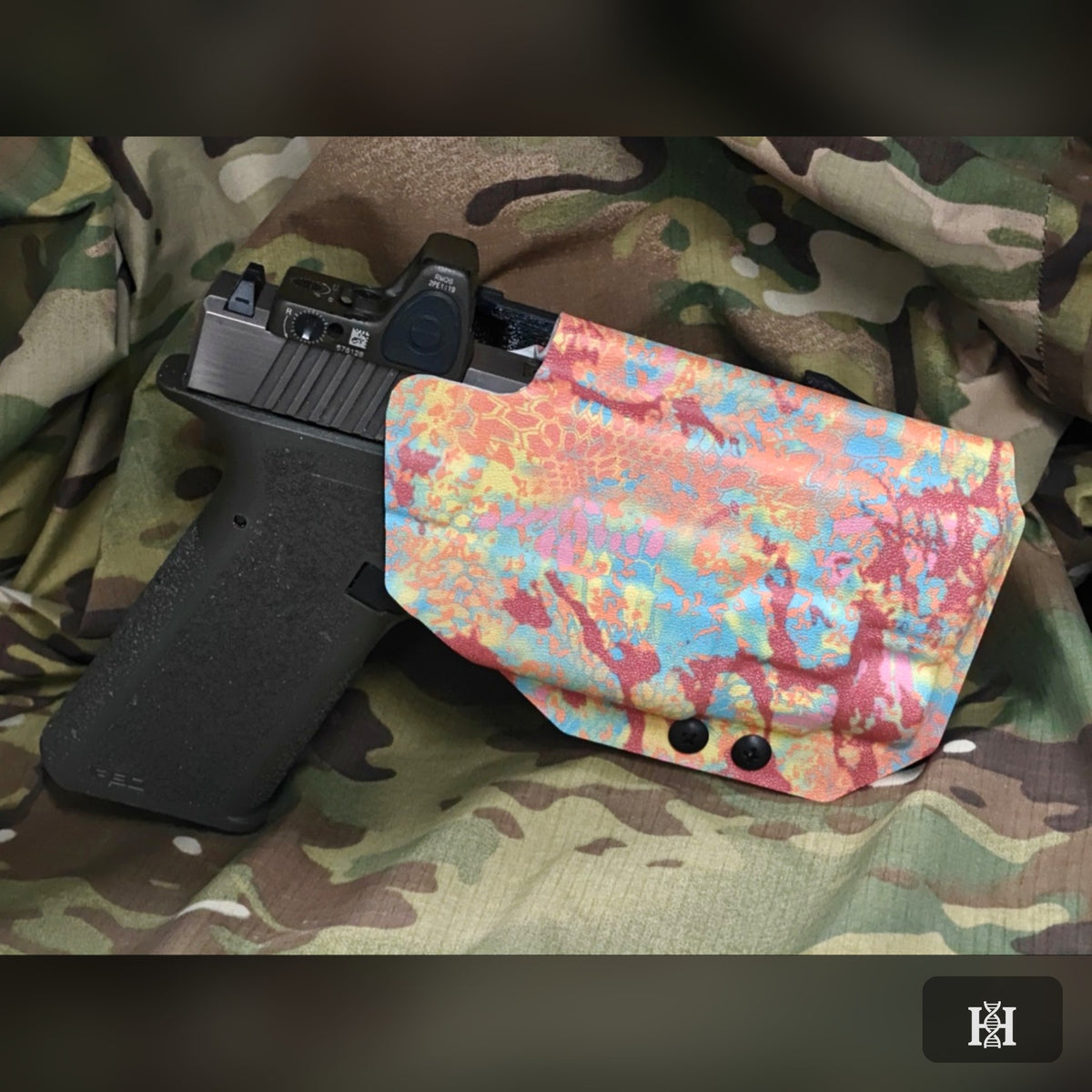 Pastel splatter-print OWB holster with pistol and red dot sight