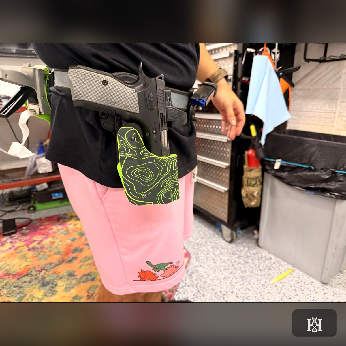Neon topo-print OWB holster worn on belt with 1911 pistol
